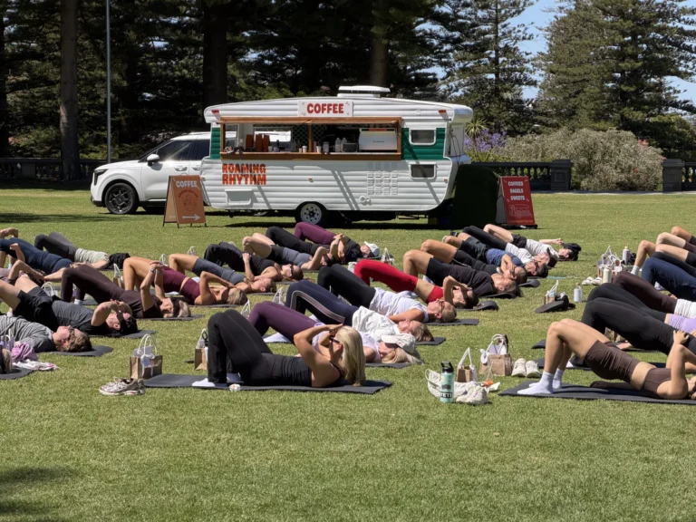Yoga class gathered beside the Roaming Rhythm coffee caravan