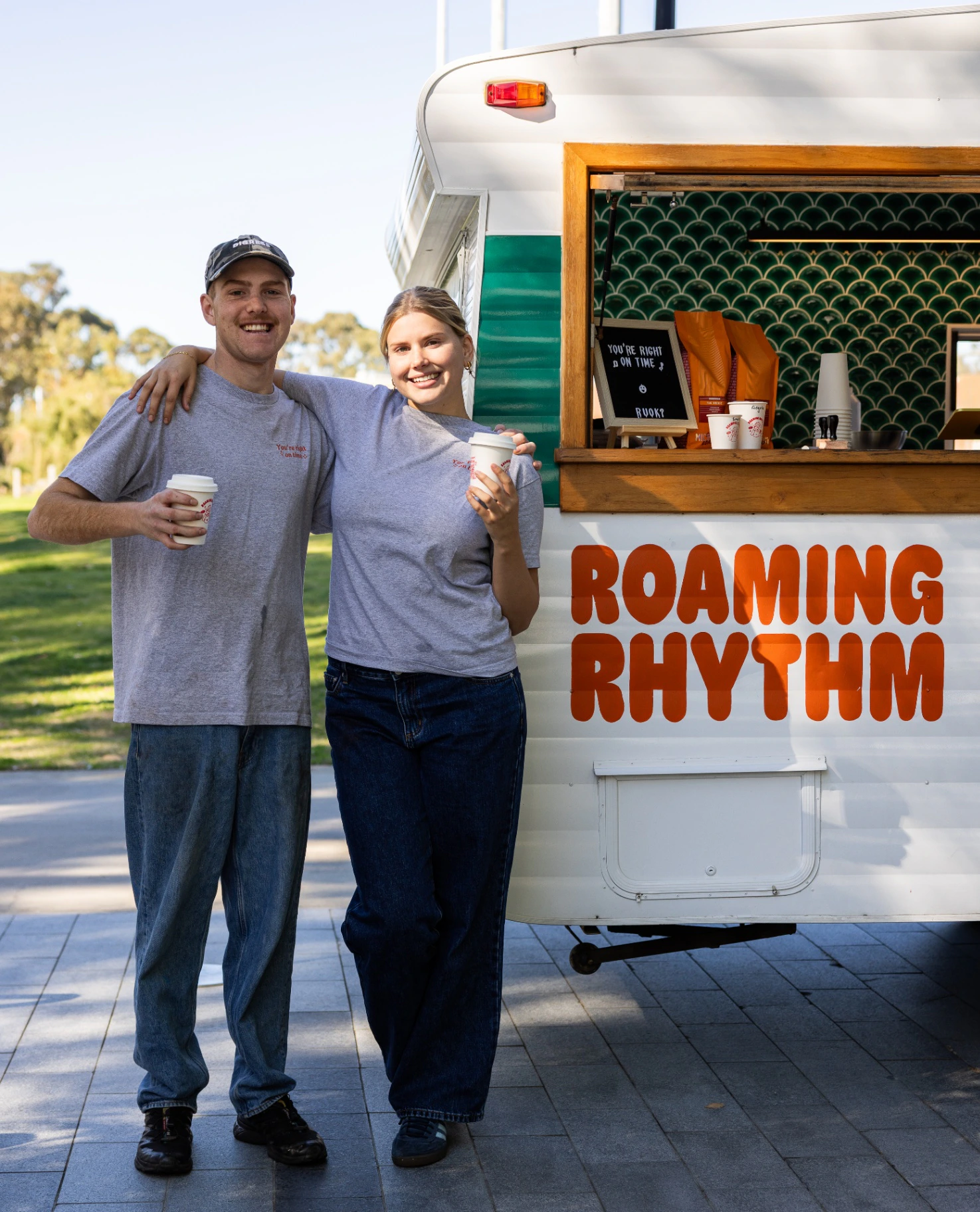 Roaming Rhythm coffee service team beside the caravan